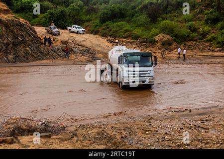 OMO VALLEY, ETHIOPIA - FEBRUARY 4, 2020: Truck stuck in swollen waters of Kizo river, Ethiopia Stock Photo