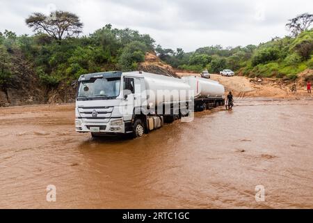 OMO VALLEY, ETHIOPIA - FEBRUARY 4, 2020: Truck stuck in swollen waters of Kizo river, Ethiopia Stock Photo