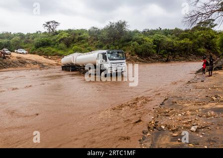 OMO VALLEY, ETHIOPIA - FEBRUARY 4, 2020: Truck stuck in swollen waters of Kizo river, Ethiopia Stock Photo