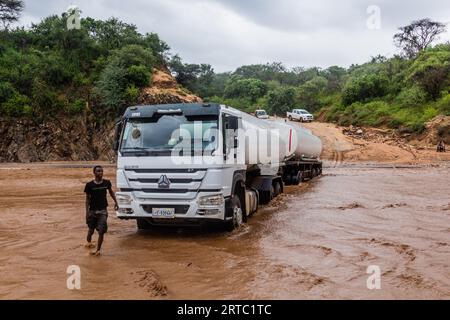 OMO VALLEY, ETHIOPIA - FEBRUARY 4, 2020: Truck stuck in swollen waters of Kizo river, Ethiopia Stock Photo