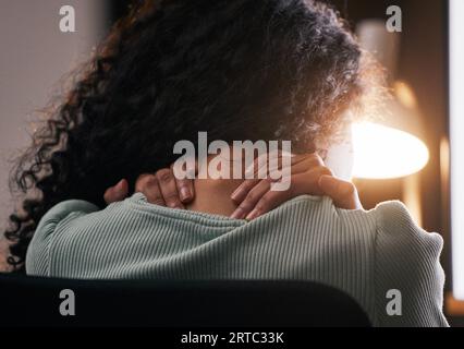Neck pain, back and woman with stress, anxiety and work burnout in office at night. Tired, massage and muscle injury and female professional hand with Stock Photo
