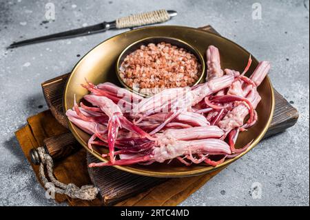 Fresh Raw Duck Tongue ready for cooking. Gray background. Top view. Stock Photo