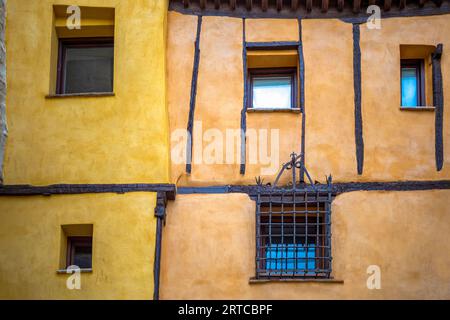 Detail of old medieval facades of the old town of Cuenca, Spain in vibrant orange and yellow colors Stock Photo