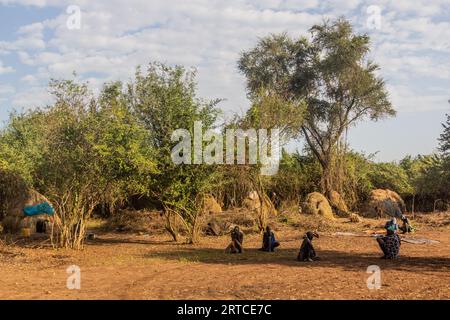 OMO VALLEY, ETHIOPIA - FEBRUARY 6, 2020: Members of Mursi tribe in their village, Ethiopia Stock Photo