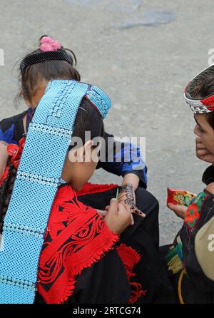 Kalash girls preparing for the Uchal Summer Festival Stock Photo