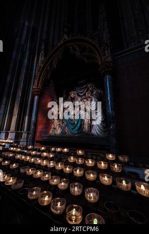 Candles and Figurines in the Cologne Cathedral Stock Photo