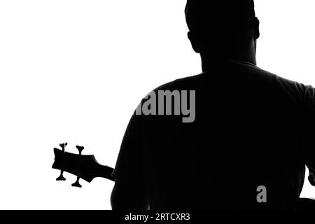 Monochrome Silhouette Of A Bass Guitarist Playing On Stage, England, UK Stock Photo