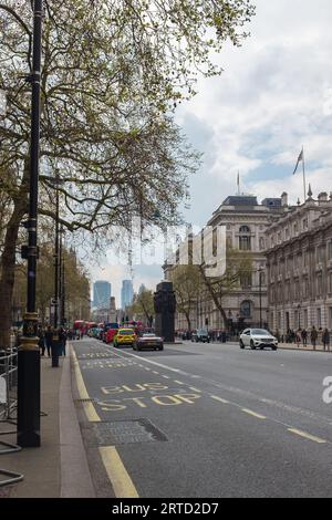 London, UK, 2023. The Cabinet Office and Downing Street, with the Monument to the Women of WWII (John W. Mills) in the background (vertical) Stock Photo