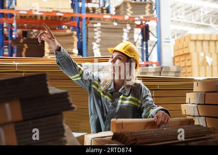 Warehouse Industrial supply chain and Logistics Companies inside. Warehouse workers checking the inventory. Products on inventory shelves storage. Wor Stock Photo