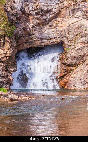 Running Eagle Falls in the Two Medicine section of Glacier National Park in Montana. Water flows both from the rock and over the top at times. Stock Photo