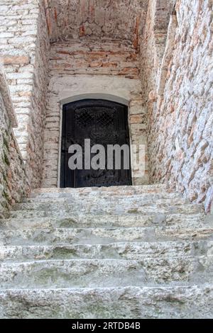historic old entrance wooden door and stone wall Stock Photo