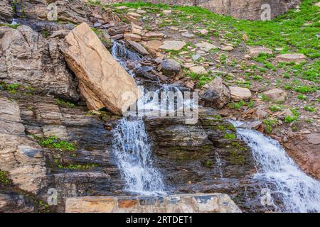 Waterfall along the side of Going to the Sun Road in Glacier National Park in Montana. Stock Photo