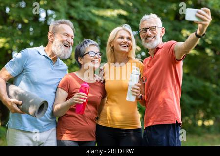 Group of happy senior people taking selfie on smartphone after outdoor training Stock Photo