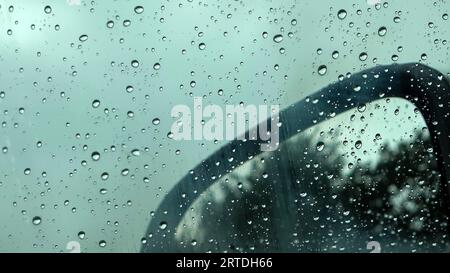 Rain Drops Running Down A Car Window In A Close Up View Stock Photo