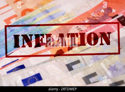 A Stamp With The Red Lettering Inflation On Numerous Euro Banknotes - Financial Crisis Concept In Germany And Europe Stock Photo