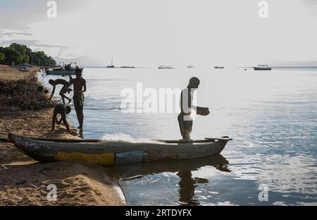 Cape Maclear, Malawi. Fishermen dock their boat after catching several fish in Lake Malawi. Editorial use only. Stock Photo