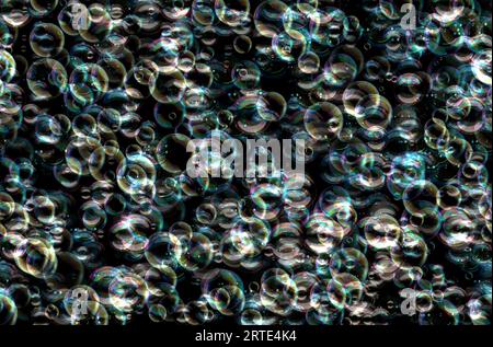 Many Colorful Soap Bubbles On A Black Background. Concept Texture Pattern. Stock Photo