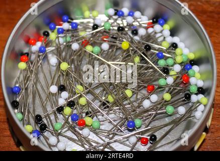 Close Up View On Lots Of Sewing Pins With Colored Heads In A Metal Box Stock Photo