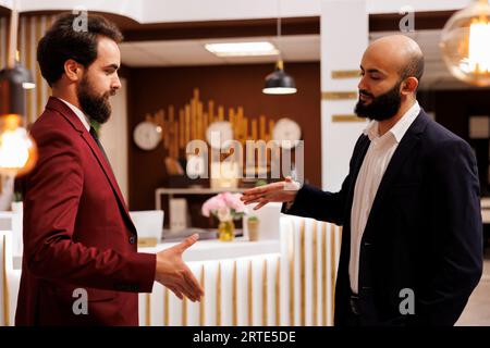 Professionals shake hands at meeting, creating new future partnership between corporations. Businessmen successfully collaborating on project at conference, handshake agreement. Stock Photo