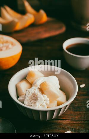 Dessert of Ice Cream Mixed with Slices of Honeydew Melon in Bowl Stock Photo