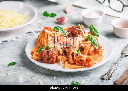 Pasta with mini meatballs, tomato sauce and parmesan cheese Stock Photo