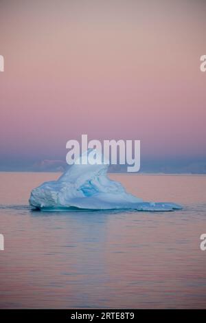 An iceberg along the Antarctic Peninsula, near the Antarctic Circle; Antarctica Stock Photo