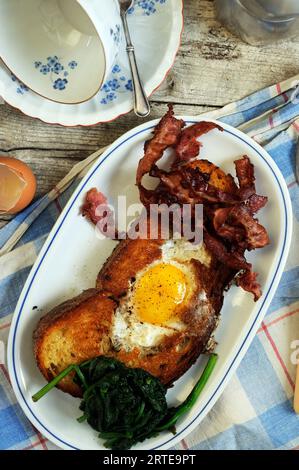 Brunch with fried eggs, bacon and spinach Stock Photo