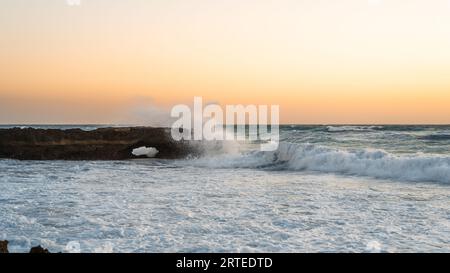 A photo of raging waves crashing into the sea. Stock Photo