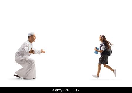 Schoolgirl running towards a man in traditional muslim clothes isolated on white background Stock Photo