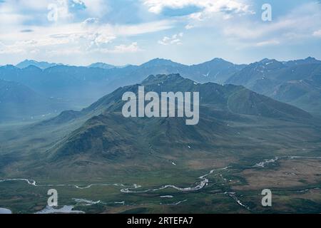 The Tombstone Mountains in summer green silhouetted against the blue sky along the Dempster Highway makes for great views from the mountaintops wit... Stock Photo