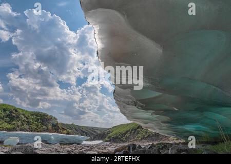 Scenic view under an overhang of the late season ice formation known as aufeis (created by multiple layers of water freezing atop one another that ... Stock Photo
