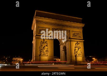 Arc de Triomphe lit up at night in Paris; Paris, France Stock Photo