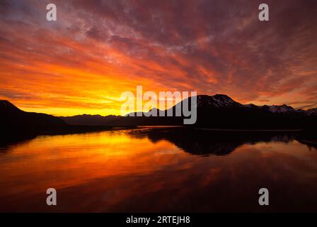 Sunset over the Kenai Peninsula reflected in Turnagain Arm, Kenai Peninsula, Alaska, USA; Kenai Peninsula, Alaska, United States of America Stock Photo