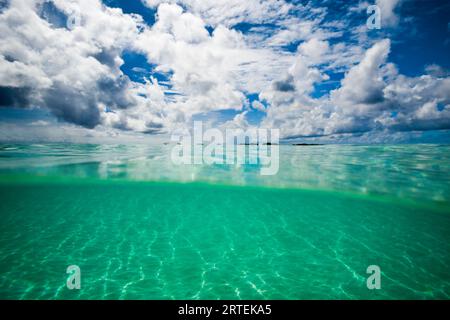 Split view of underwater, surface level of the Caribbean Sea  and cloudy sky as viewed off the island of Aruba; Aruba, Kingdom of the Netherlands Stock Photo