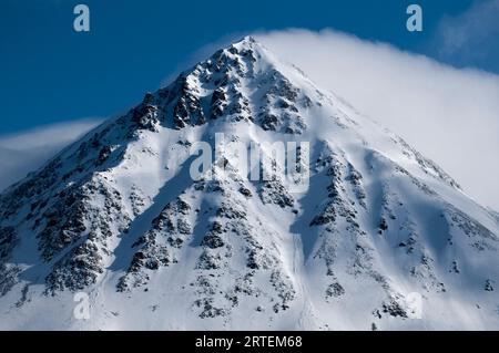 Cloud and spindrift on a mountain peak; Spitsbergen, Svalbard Archipelago, Norway Stock Photo