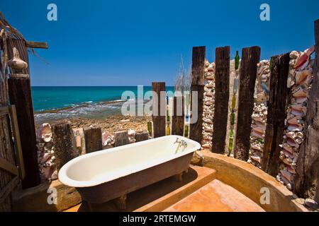 Outdoor bathtub along the coast of a resort in Jamaica; Treasure Beach, Jamaica, West Indies Stock Photo