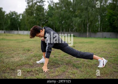 Young woman stretching legs before workout Stock Photo