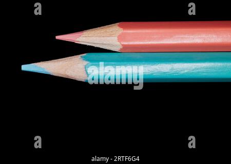 Pink and Aqua Blue Colored Pencils isolated on Black Stock Photo