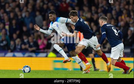 Glasgow. 13th Sep, 2023. England's Marcus Rashford (L) vies for the ball during a friendly match between Scotland and England in Glasgow, Britain, on Sept. 12, 2023. Credit: Xinhua/Alamy Live News Stock Photo