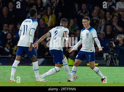 Glasgow. 13th Sep, 2023. England's Phil Foden (R) celebrates with teammate Kyle Walker after scoring the opening goal during a friendly match between Scotland and England in Glasgow, Britain, on Sept. 12, 2023. Credit: Xinhua/Alamy Live News Stock Photo