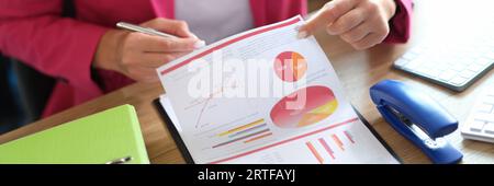 Manager working with financial reports while sitting at table in office. Stock Photo