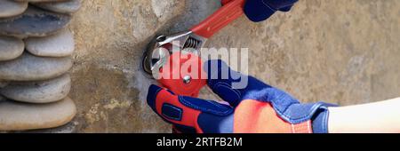 Craftsman installs water faucet on concrete wall close-up. Stock Photo