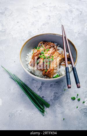 Rice with enoki mushrooms and chives. Asian vegan diet meal. Stock Photo