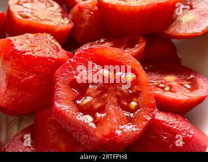 Detailed macro shot capturing the rich texture and color of a succulent red tomato. Stock Photo