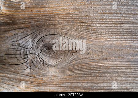 Closeup view of weathered natural texture with knot on old wood board - beautiful textured background Stock Photo