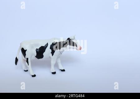 a plastic toy cow on a white background Stock Photo