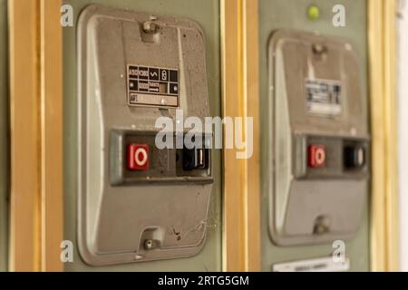 Milan, Italy 19 august 2023: Close-up of aged, obsolete high-voltage electrical switches with a nostalgic industrial feel. Stock Photo