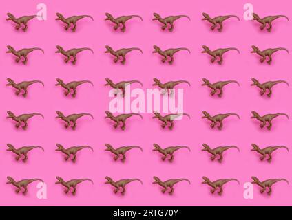 plastic toy dinosaurs on pink background pattern Stock Photo