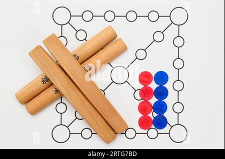 Yut is a traditional Korean board game that uses four wooden sticks called yut. Translation of Text : Good luck. Stock Photo