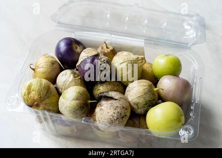 Tomatillos, green tomatoes, with salsa verde, green sauce, in a molcajete, traditional Mexican mortar. organc food. Stock Photo
